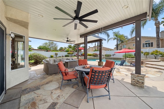 view of patio / terrace with an outdoor fire pit, a ceiling fan, a fenced in pool, and a fenced backyard