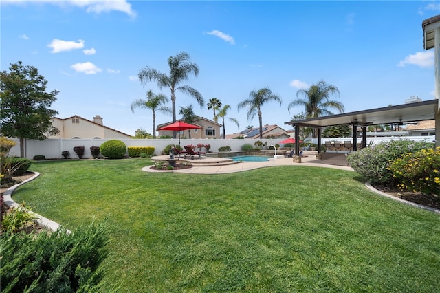 view of yard featuring a patio, a fenced in pool, and a fenced backyard