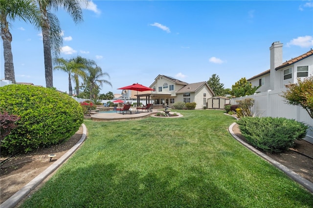 view of yard featuring a fenced backyard, an outdoor structure, a patio, and a storage shed