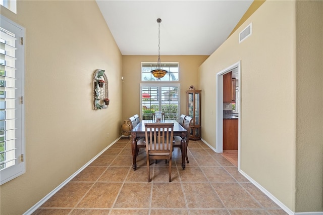 dining area featuring baseboards, light tile patterned floors, and visible vents
