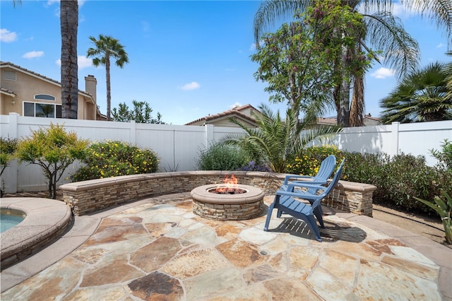 view of patio / terrace with a fire pit and a fenced backyard