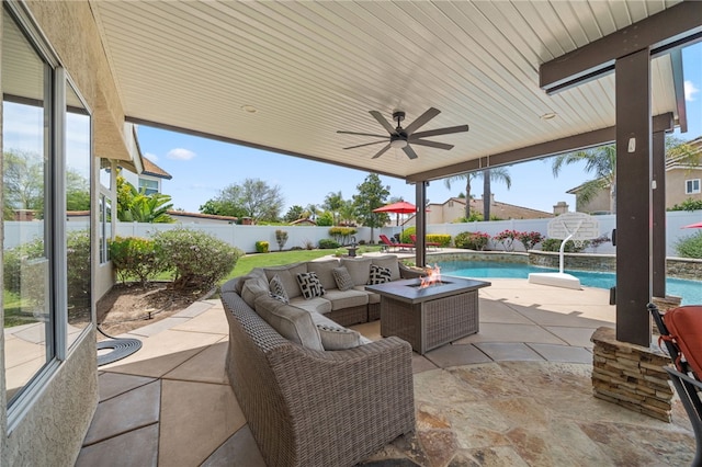 view of patio with an outdoor living space with a fire pit, a ceiling fan, a fenced in pool, and a fenced backyard