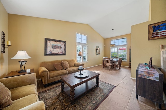 living area featuring light tile patterned floors, baseboards, and lofted ceiling