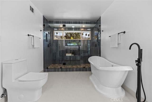 full bath featuring toilet, visible vents, tile patterned floors, a shower stall, and a soaking tub