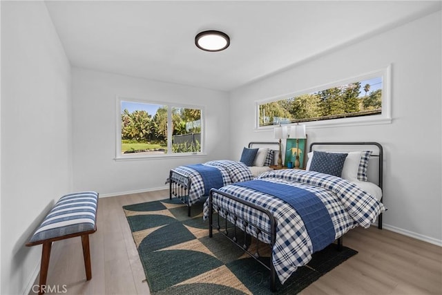 bedroom featuring baseboards and wood finished floors