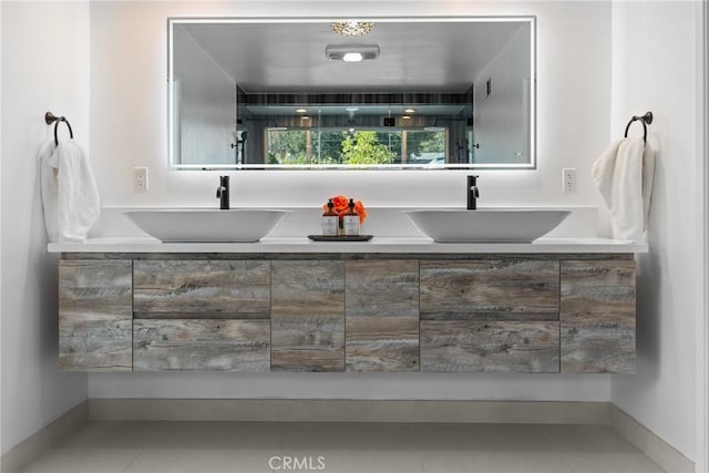 bathroom featuring double vanity, tile patterned flooring, and a sink