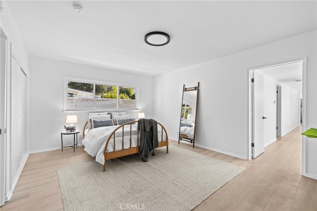 bedroom with baseboards and light wood-style floors