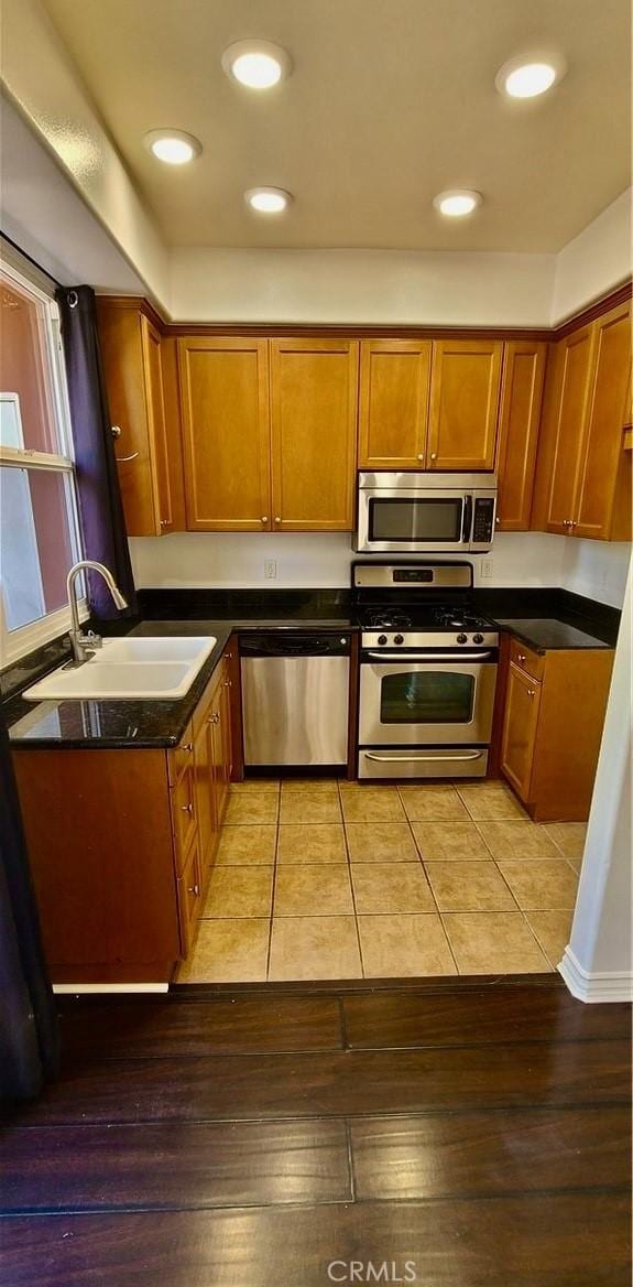 1500 Pine Ave Unit 19, Long Beach, CA 90813 - kitchen featuring appliances with stainless steel finishes, a sink, brown cabinets, dark countertops, and recessed lighting