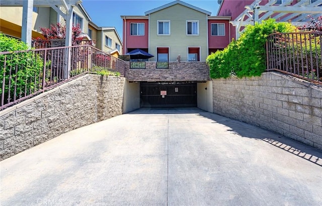 1500 Pine Ave Unit 19, Long Beach, CA 90813 - exterior space with an attached garage and concrete driveway