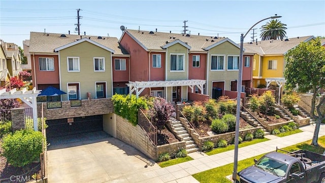 1500 Pine Ave Unit 19, Long Beach, CA 90813 - townhome / multi-family property with stairway, driveway, an attached garage, and a residential view