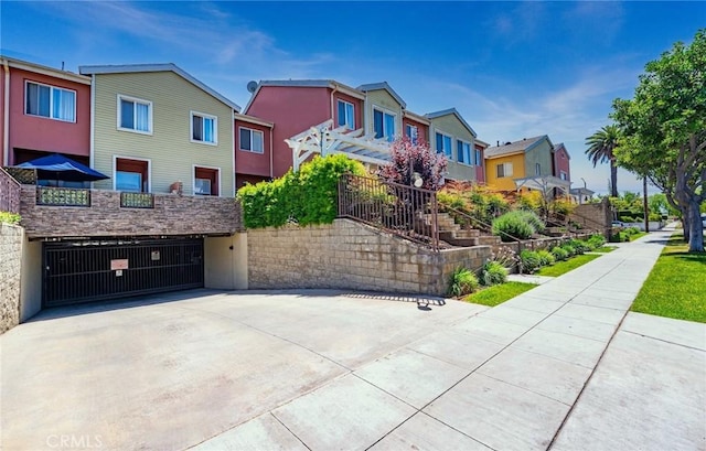 1500 Pine Ave Unit 19, Long Beach, CA 90813 - view of front of home with an attached garage, a residential view, and concrete driveway