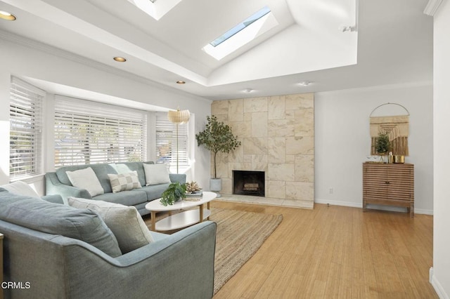 living area featuring crown molding, wood finished floors, a fireplace, and recessed lighting