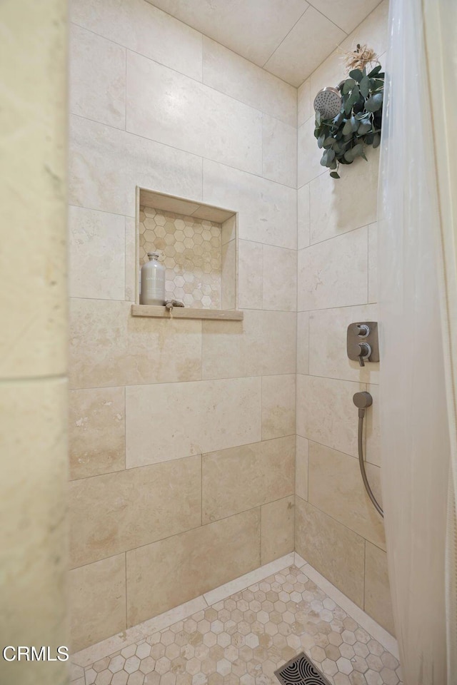 full bathroom with a tile shower