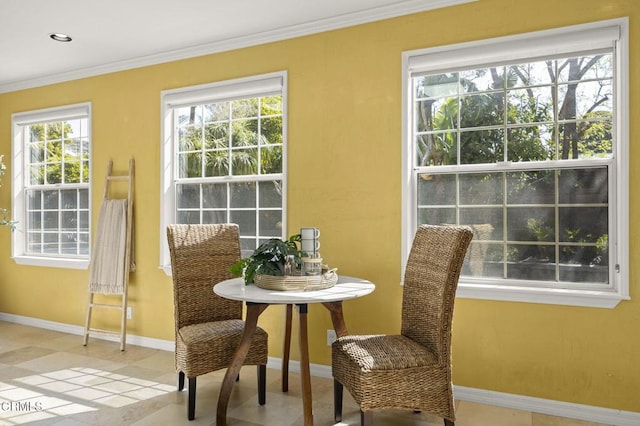 dining room featuring ornamental molding and baseboards