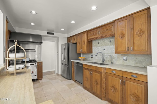 kitchen with a sink, brown cabinets, visible vents, light countertops, and appliances with stainless steel finishes