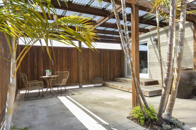 view of patio / terrace with outdoor dining area, a pergola, and fence