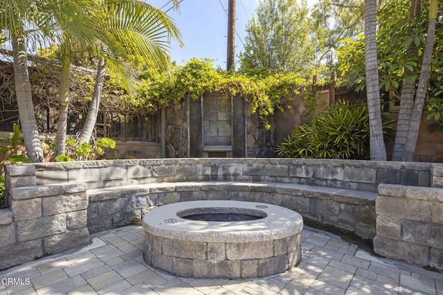 view of patio / terrace featuring an outdoor fire pit and a fenced backyard