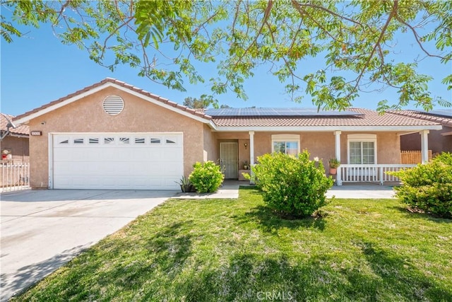15055 Kingsford Ave, Adelanto, CA 92301 - single story home with stucco siding, a tile roof, a garage, solar panels, and concrete driveway