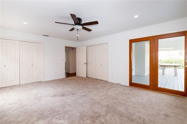 unfurnished bedroom featuring recessed lighting, multiple closets, visible vents, and carpet