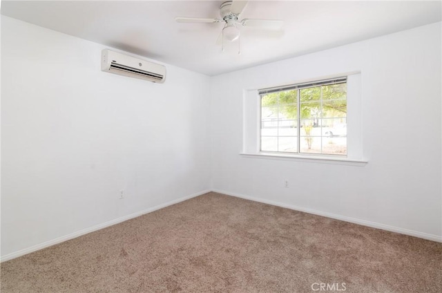 spare room featuring baseboards, a wall unit AC, and carpet floors