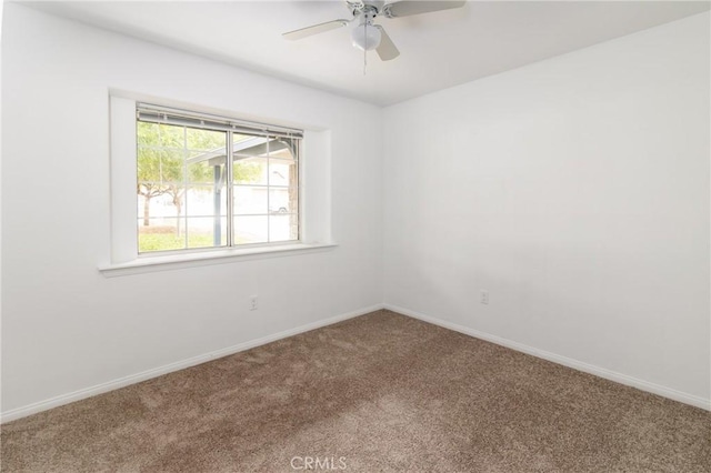 carpeted empty room with baseboards and ceiling fan