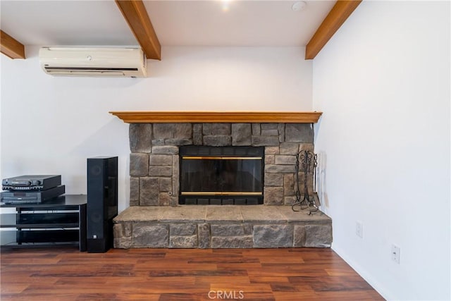 room details with wood finished floors, beam ceiling, a fireplace, a wall unit AC, and baseboards