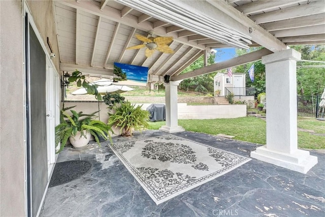 view of patio / terrace featuring a storage shed, an outbuilding, fence, and ceiling fan
