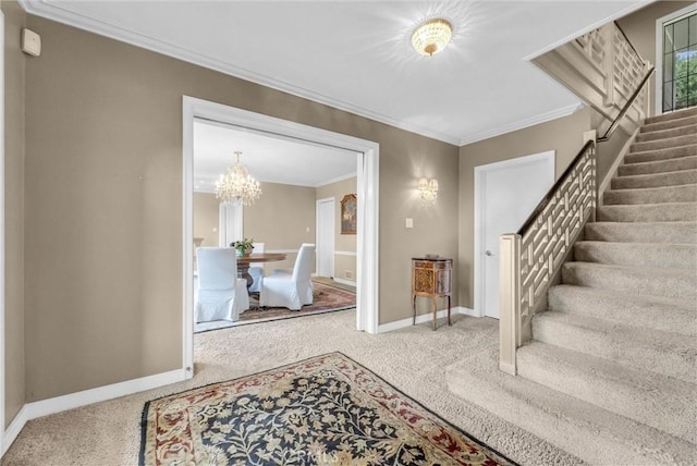 carpeted foyer entrance with baseboards, stairway, a chandelier, and ornamental molding