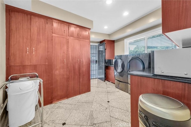 laundry room featuring washing machine and dryer, granite finish floor, and recessed lighting