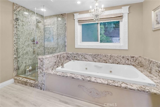 full bath featuring a shower stall, a notable chandelier, recessed lighting, and a whirlpool tub