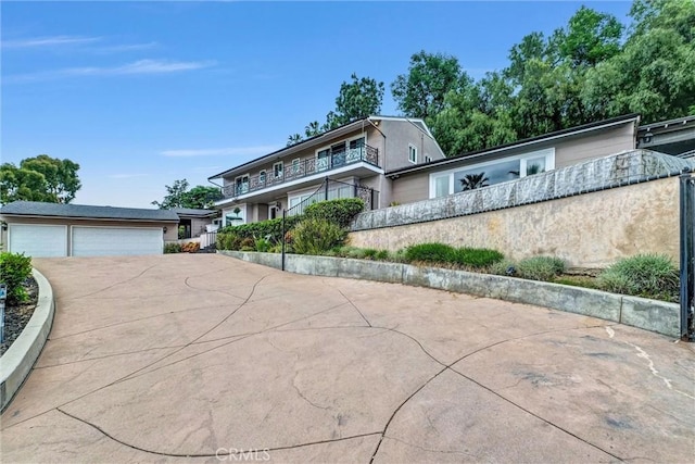 traditional home featuring concrete driveway, a garage, and stucco siding