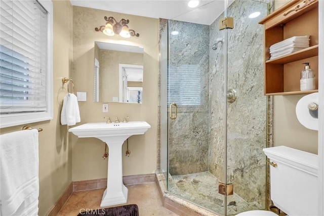 full bathroom with toilet, baseboards, tile patterned flooring, and a shower stall