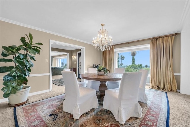 dining space featuring carpet flooring, a notable chandelier, crown molding, and baseboards