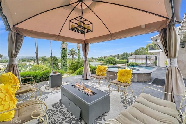 view of patio / terrace with a hot tub, a gazebo, a fire pit, and an outdoor pool