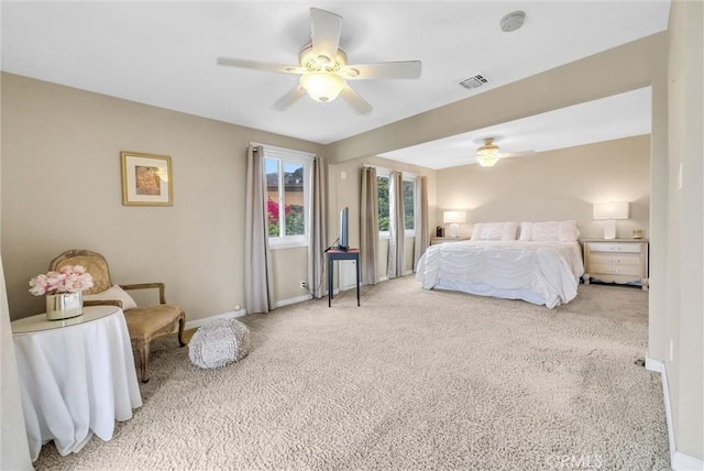 bedroom with baseboards, a ceiling fan, visible vents, and carpet