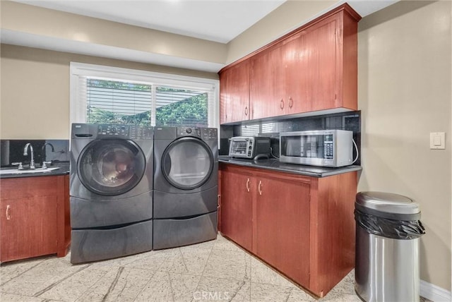 laundry room featuring washer and clothes dryer, a toaster, baseboards, and a sink