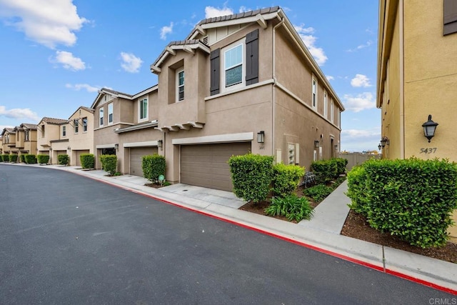 5441 San Roberto, San Diego, CA 92154 - view of front of property with an attached garage, stucco siding, and a residential view