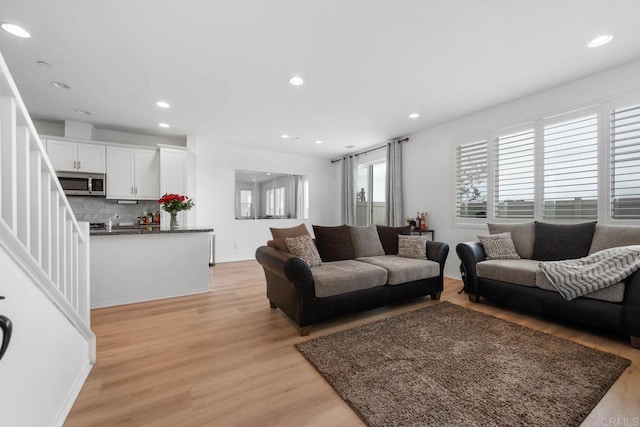 5441 San Roberto, San Diego, CA 92154 - living area featuring light wood-type flooring, stairs, and recessed lighting