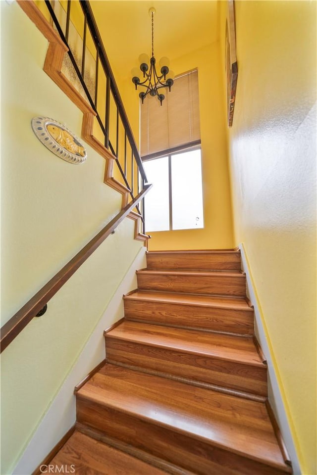 1840 S Summer Pl, West Covina, CA 91792 - staircase with a chandelier, a high ceiling, and baseboards