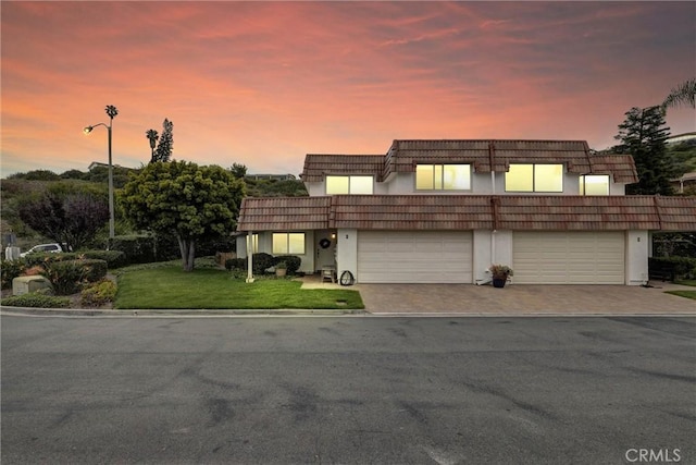 1 Vista Del Ponto, San Clemente, CA 92672 - view of property with a lawn, driveway, a garage, stucco siding, and mansard roof