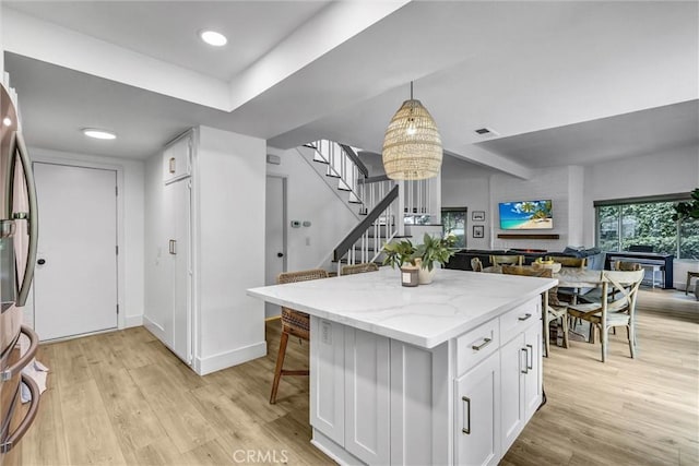 1 Vista Del Ponto, San Clemente, CA 92672 - kitchen with light wood finished floors, open floor plan, light stone counters, and white cabinets