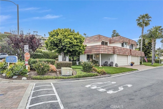 1 Vista Del Ponto, San Clemente, CA 92672 - view of front of house with mansard roof, stucco siding, and a garage