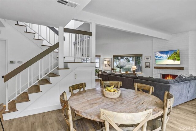 1 Vista Del Ponto, San Clemente, CA 92672 - dining area featuring stairway, a fireplace, visible vents, and wood finished floors