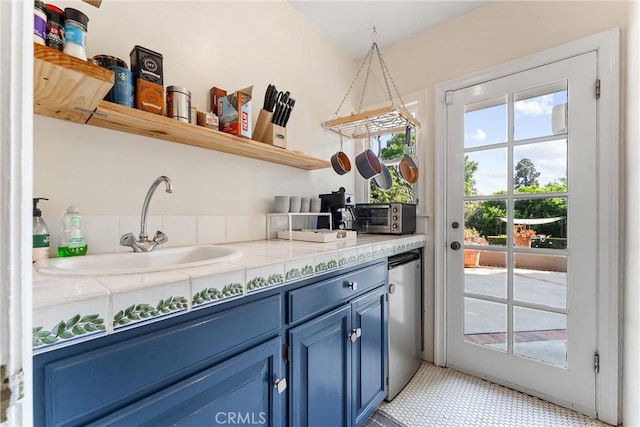 interior space featuring a toaster, fridge, and a sink