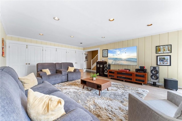living room with stairs, light wood-style floors, recessed lighting, and crown molding