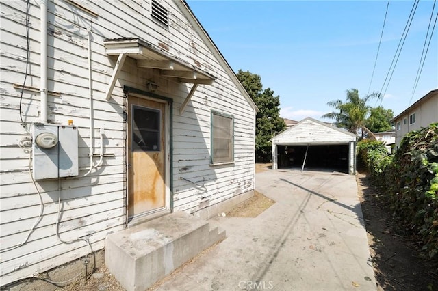 view of exterior entry with a detached carport