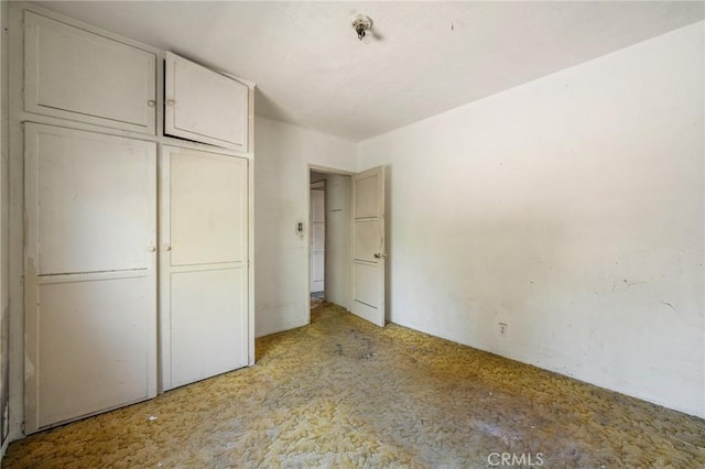 unfurnished bedroom with carpet and a closet