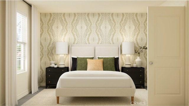 bedroom with carpet flooring, baseboards, and multiple windows