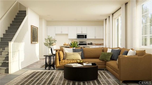 living room with baseboards and stairs