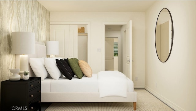 carpeted bedroom with a closet and baseboards